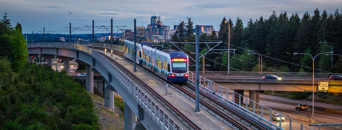East Link car on rail line with Seattle, WA skyline in the background